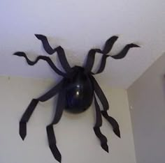 a black spider sculpture hanging from the ceiling