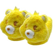 two yellow stuffed animal slippers with horns on the ears and nose are facing each other