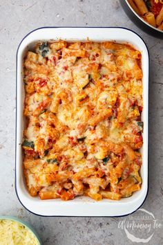 a casserole dish filled with pasta and cheese next to a bowl of macaroni and cheese