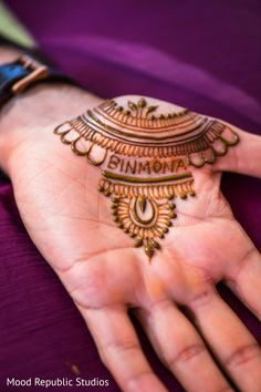 a woman's hand with henna on it and the words simora written in arabic