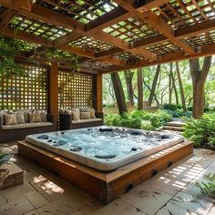 an outdoor hot tub in the middle of a patio with couches and trees around it