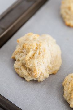 three biscuits on a baking sheet ready to be baked