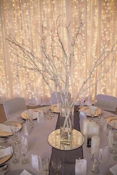 a dining room table is set with silverware and place settings for an elegant dinner