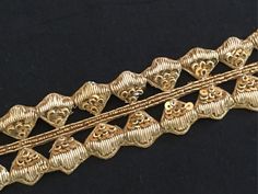 a gold bracelet with hearts on it