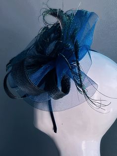 Transform your midnight look with our stunning peacock Fascinator Hat, adorned with butterflies in various shades of Blue and black with hints of green. This whimsical headpiece is perfect for adding a touch of magic and sophistication to any special event! Age Group/Gender - Adult/Women Size/Type - One size fits all adults Color - Blues, green and touch of black Special Features - peacock feathers on fascinator base Elegant Carnival Party Headband, Elegant Hair Accessories For Party And Carnival, Elegant Party Hair Accessories For Carnival, Elegant Evening Headband For Carnival, Elegant Carnival Evening Hair Accessories, Elegant Headband Fascinator For Costume Party, Elegant Headband For Masquerade, Carnival Evening Headband Hair Accessories, Adjustable Hair Accessories For Evening Carnival