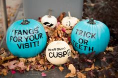 three blue pumpkins with words written on them