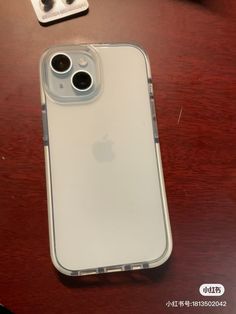 an iphone case sitting on top of a wooden table