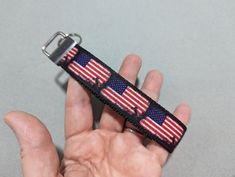 a hand holding an american flag wristband