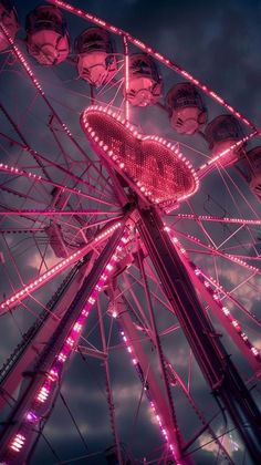 a ferris wheel with pink lights on it