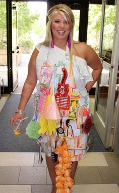 a woman in an apron is walking down the hall with food on her feet and legs