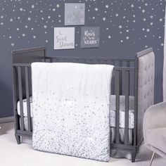 a baby crib in a room with stars on the wall