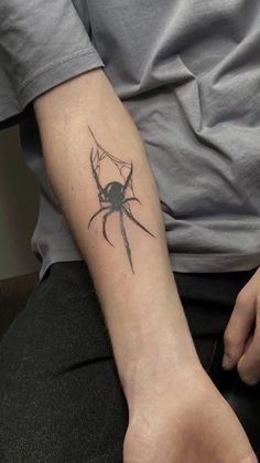 a person with a spider tattoo on their arm