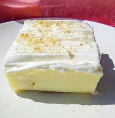 a piece of cake sitting on top of a white plate next to a red chair