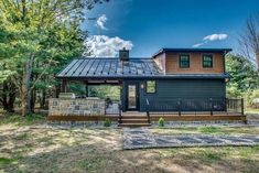 a house with a metal roof in the woods