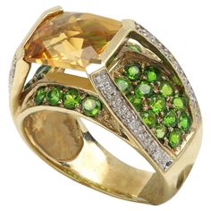 Unique Multi Color Gemstone Ring Center Yellow Citrine with side Diamonds And Green Tsavorite 10k Yellow Gold 6.4 grams Finger Size 7 Center Citrine is approx 10 x 8 mm. Made interesting like two Dimension / Layers with an unusual beauty.