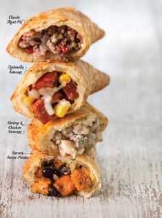 three burritos stacked on top of each other with different fillings and toppings