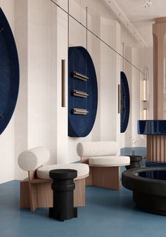 the room is decorated in blue and white with circular mirrors on the wall above it