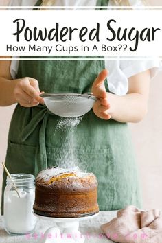 a woman in an apron is sprinkling sugar on a cake with a bowl