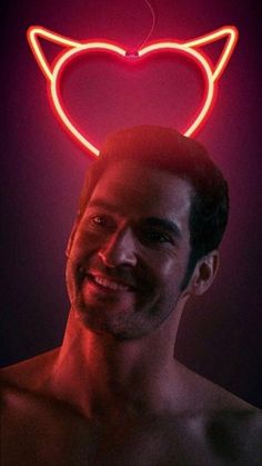 a man is smiling while wearing a neon cat head