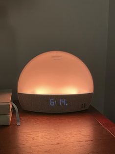 an alarm clock sitting on top of a wooden table