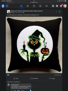 a black and white pillow with an image of a green witch holding a lit candle