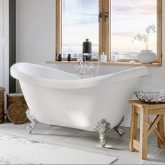 a white bath tub sitting next to a window