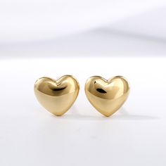 The perfect anytime surprise, these whimsical heart-shaped fashion stud earrings lend a touch of shine to her attire. Crafted in sterling silver, each dainty puffed heart gleams with anytime appeal. So sweet and charming, these heart stud earrings are sure to become an instant favorite.Weight: 1.16 gWidth: 6.6 mmHeight: 5.8 mmThickness: 2.2 mmMaterial: 925 SilverPlating Color: Yellow Gold Luxury Yellow Gold Heart Earrings With Cubic Zirconia, Heart Earings Piercings, Earrings Gold Heart, Affordable Vintage Heart-shaped Jewelry, Heart Shape Earrings Gold, Heart Earrings Gold, Heart Gold Earrings, Sterling Silver Heart Earrings Tarnish Resistant For Everyday, Sterling Silver Tarnish Resistant Clip-on Earrings For Gift