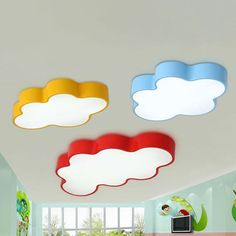 there are three clouds painted on the ceiling in this room, one is red and one is blue