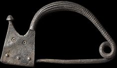 an old iron hook on a black background with the handle still attached to it's side