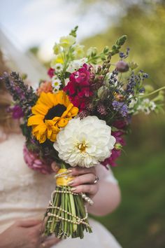 a woman holding a bouquet of flowers in her hands with the caption send me