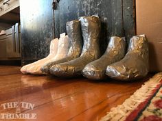 five pairs of boots are lined up on the floor