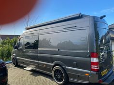 a grey van parked in front of a house