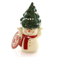 a ceramic figurine with a christmas tree on top