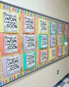 a bulletin board with magnets on it in a school hallway that says magic work soon