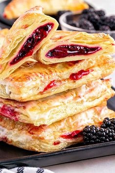 a stack of crepes with berries on the side