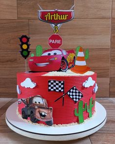 a birthday cake decorated with cars and traffic lights