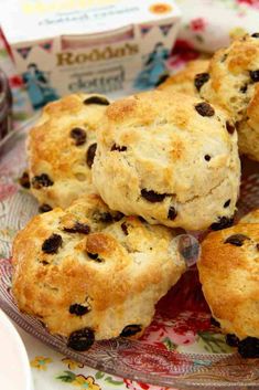 several biscuits on a glass plate with jam in the background