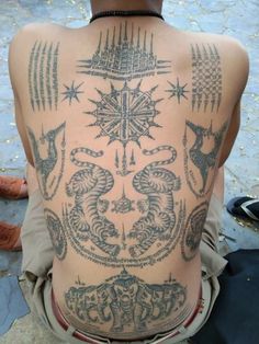 the back of a man with tattoos on his body