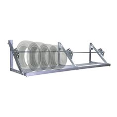 a metal shelf with three plates on it and two wheels attached to the back wall