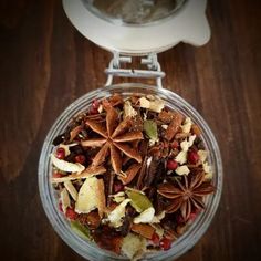 a glass bowl filled with fruit and nuts