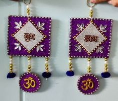 two purple and gold earrings with beads hanging from them