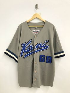 "PLEASE READ DESCRIPTION CAREFULLY BEFORE BUYING..IF YOU HAVE ANY QUESTION FEEL FREE TO ASK Vintage 90s Karl Kani Baseball shirt Made in Korea Size: XXL Please check the actual measurements below- (All measurements were taken lying flat) ACTUAL SIZE MEASUREMENT(approximately) : ARM PIT TO ARM PIT :- 28.5\" inches LENGTH ( BACK COLLAR TO BOTTOM ):-35\" inches CONDITION :-VINTAGE CONDITION!! SMALL HOLE at back..NO STAINS (Refer photos) An item that has been used  GREAT VINTAGE CONDITION ( USED CLO Cheap Casual Breathable Baseball Jersey, Cheap Cotton Crew Neck Baseball Jersey, Cheap Baseball Jersey Fan Merchandise With Short Sleeves, Cheap Customizable Tops With Baseball Collar, Cheap Customizable Top With Baseball Collar, Karl Kani 90s, Korean Hip Hop Fashion, 90s Hip Hop Outfits, Hip Hop 90s