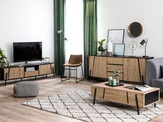 a living room filled with furniture and a flat screen tv on top of a wooden table