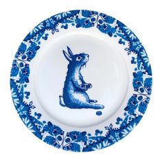 a blue and white plate with an image of a rabbit sitting on top of it