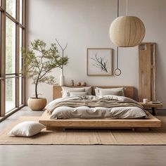 a large bed sitting next to a window in a room with white walls and wooden furniture