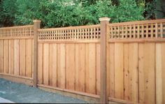 a wooden fence is shown in front of some trees