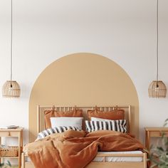 a bed with brown sheets and pillows in a white room next to a plant on the floor