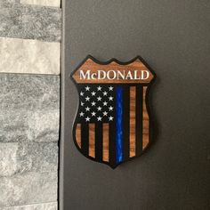 a wooden sign with an american flag and the word mcdonald on it's side