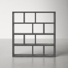 Compartmentalize your collection. With its 15 asymmetrical cubbies, this Scandi-inspired bookcase offers plenty of styling + storage opportunities. It stands either horizontally or vertically, and the open back lets light through if you use it as a room divider. Wall anchor included for stability. AllModern Color: Concrete Gray, Size: (4 Shelves) 63" H x 59" W x 13" D AllModern Stetson Geometric Bookcase in Concrete Gray | Size (4 Shelves) 63" H x 59" W x 13" D Room Divider Wall, Geometric Bookcase, Color Concrete, Office Bookcase, Divider Wall, Wall Anchors, Grey Wood, Cubbies, All Modern