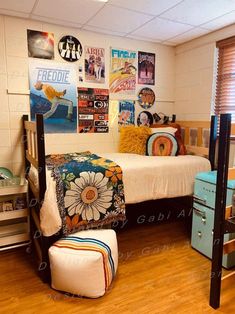 a bed room with a neatly made bed and pictures on the wall